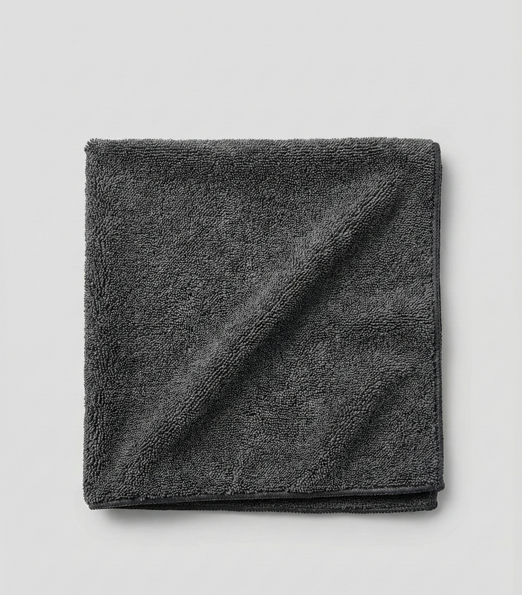 AutoPrro Folded dark gray towel on a light gray background