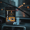 Autoprro Clear Tabs car window cleaning product on a car dashboard with raindrops on the windshield.