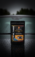 Autoprro windshield glass cleaner tablets packaging on a car dashboard with a blurred background