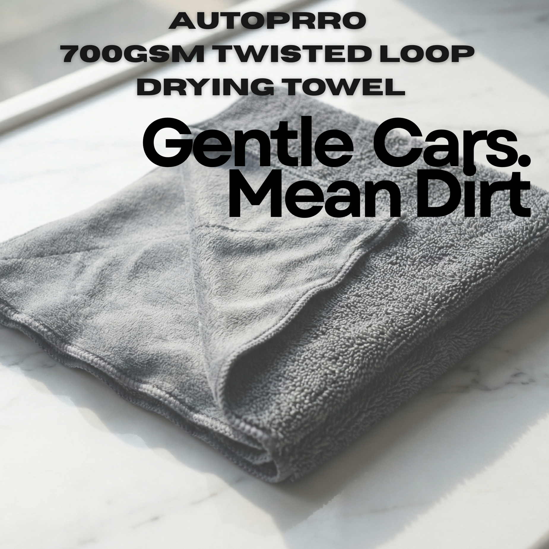 Folded gray towel with text about AUTOPRRO 700GSM twisted loop drying towel on a white background